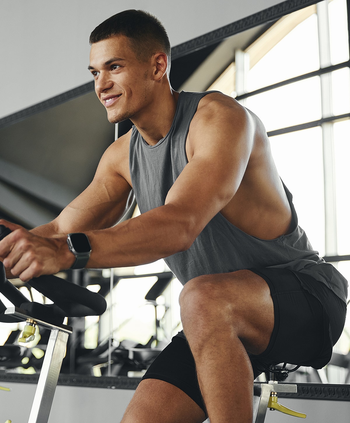 Man exercising on a stationary bike in gym.